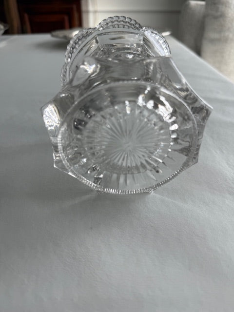 Vintage pressed glass biscuit barrel or cookie jar featuring a decorative metal lid and pinwheel design