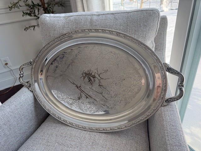 Oneida silver plated oval serving tray with ornate floral engravings.