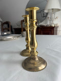 Solid brass taper candle holders with spindle stem and circular base.
