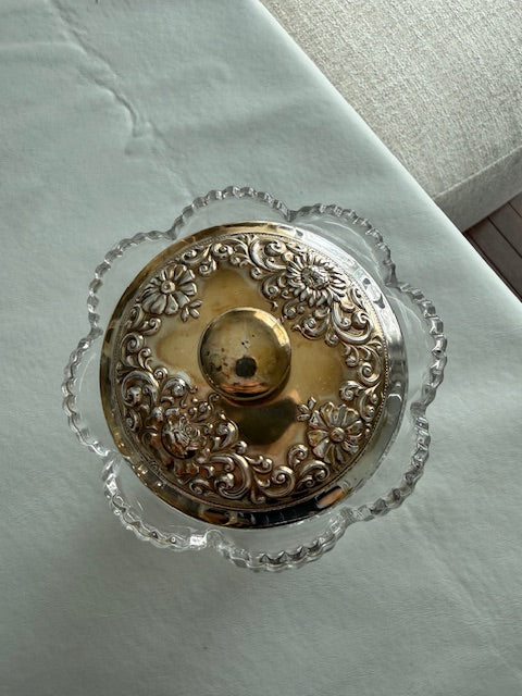 Vintage pressed glass biscuit barrel or cookie jar featuring a decorative metal lid and pinwheel design