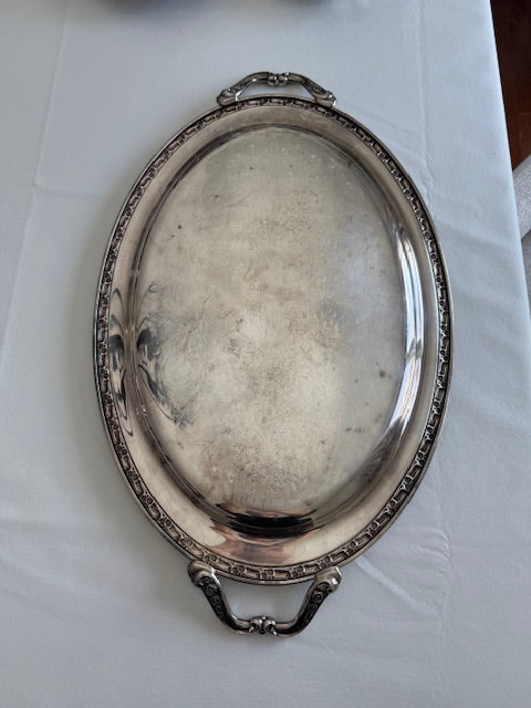 Oneida silver plated oval serving tray with ornate floral engravings.