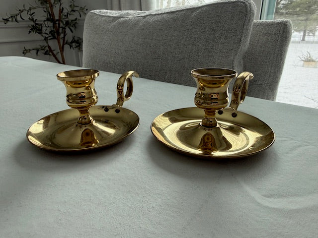Vintage pair of Baldwin brass chamberstick candle holders designed with a finger loop.