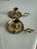 Vintage pair of Baldwin brass chamberstick candle holders designed with a finger loop.