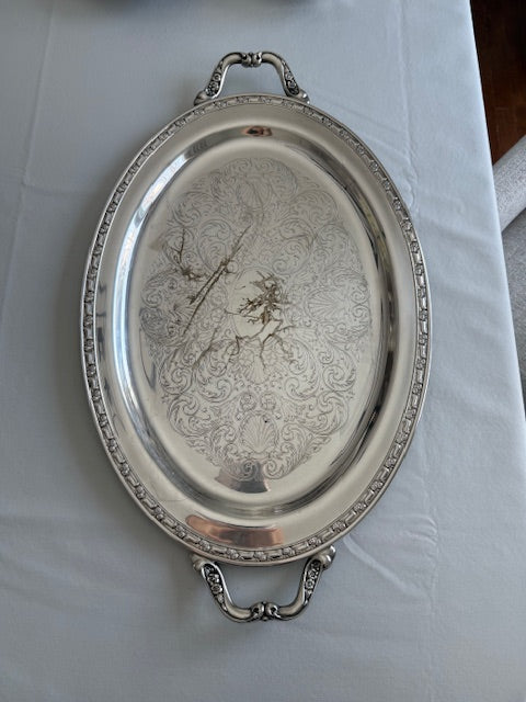 Oneida silver plated oval serving tray with ornate floral engravings.