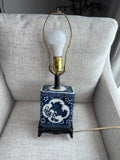Vintage Chinese blue and white porcelain table lamp featuring a foo dog design.