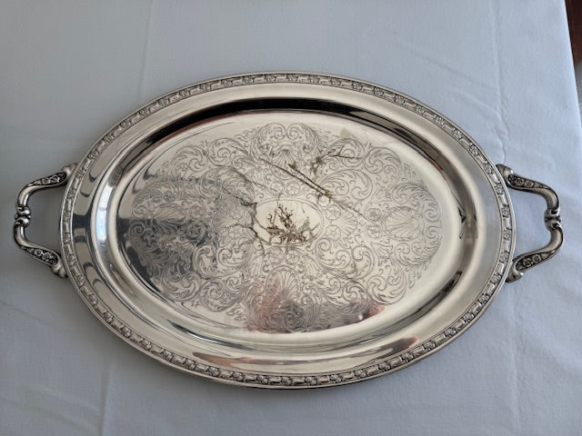 Oneida silver plated oval serving tray with ornate floral engravings.