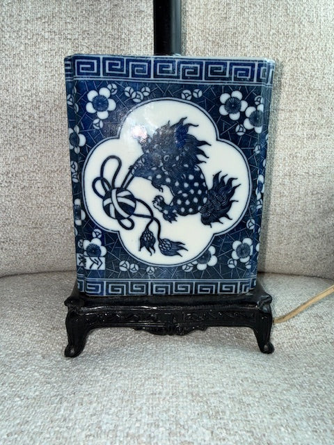 Vintage Chinese blue and white porcelain table lamp featuring a foo dog design.