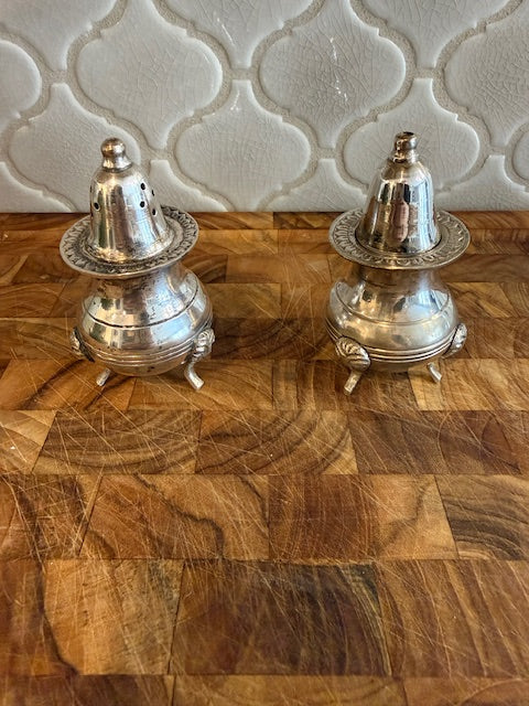 Vintage style salt and pepper shakers silver plated with feet.