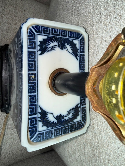 Vintage Chinese blue and white porcelain table lamp featuring a foo dog design.
