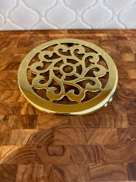 Baldwin solid brass trivet on feet.