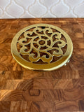 Baldwin solid brass trivet on feet.