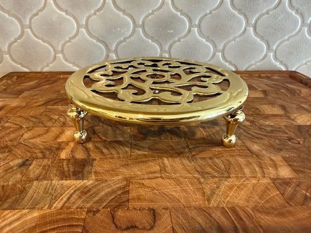 Baldwin solid brass trivet on feet.