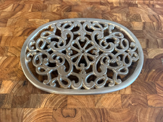 Vintage trivet with hanger.