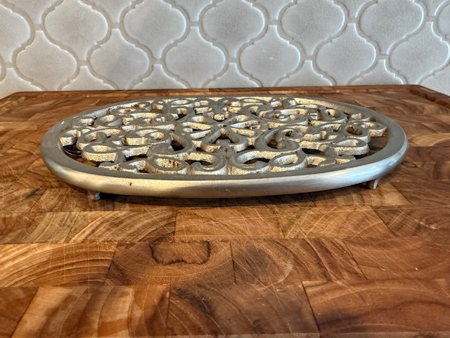 Vintage trivet with hanger.